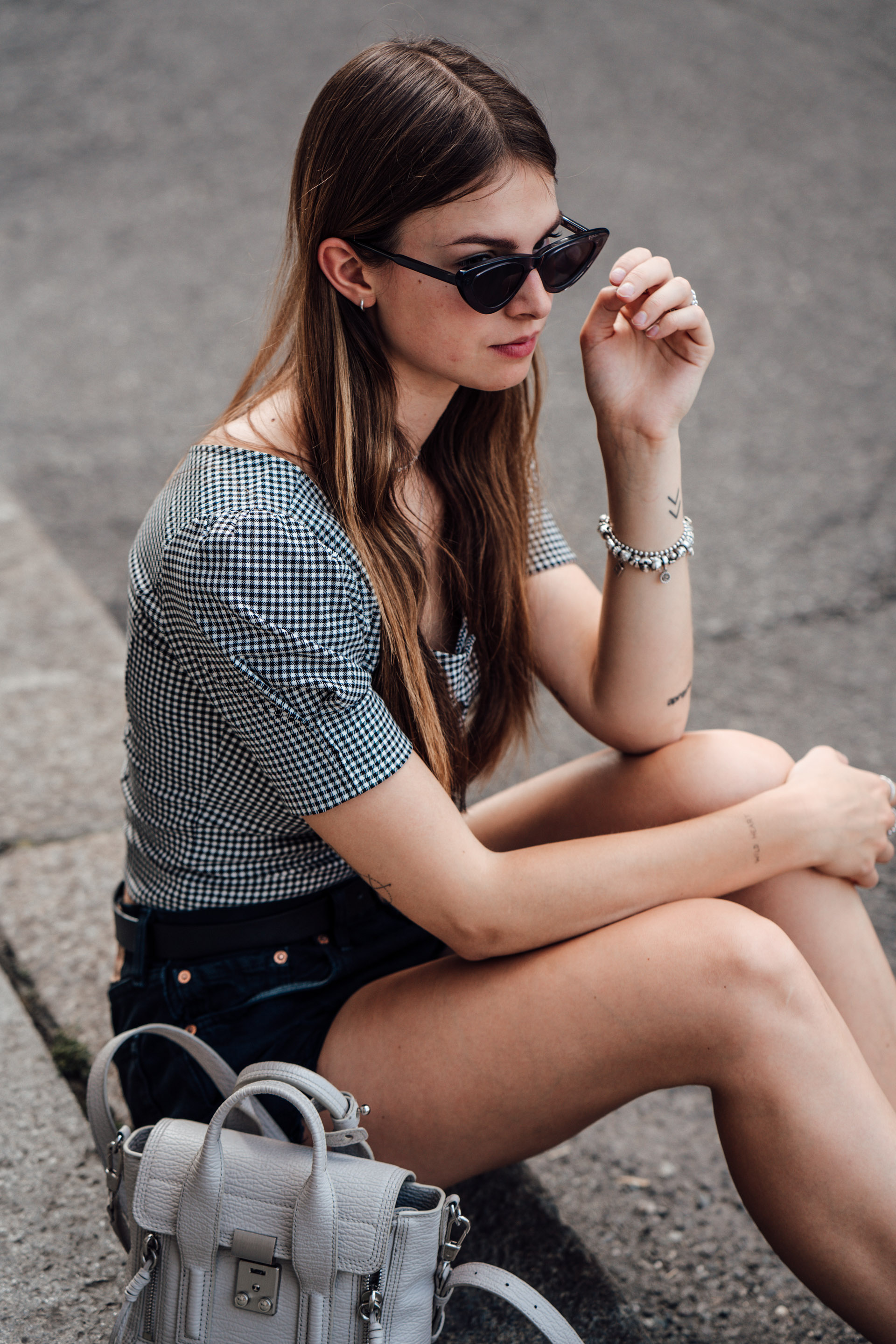 Travel Outfit: Gingham Blouse combined with black Denim Shorts